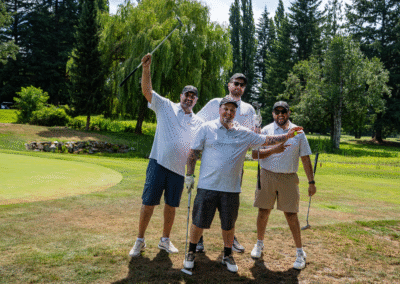 4 Male Golfers pose on the green