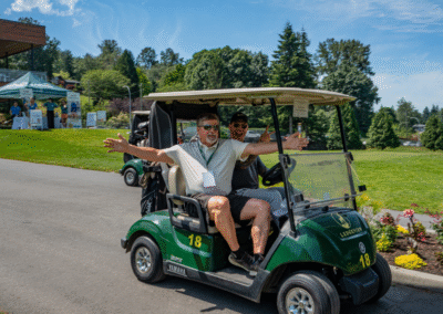 2 male golfers drive a golf cart